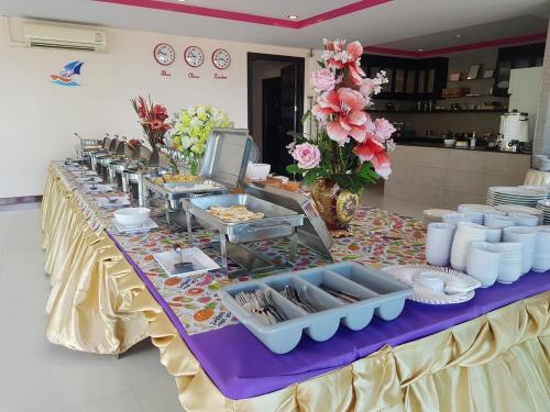a table with a buffet of food on it at The Sand Beach Pattaya in Na Jomtien
