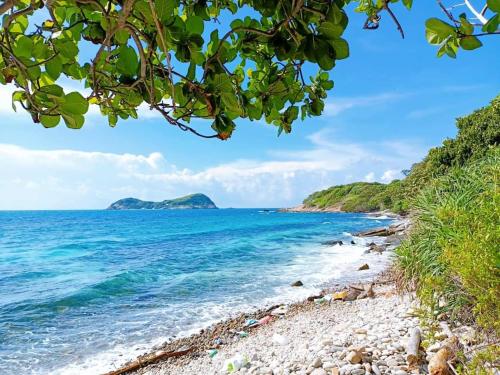 a beach in the philippines with a view of the ocean at Hotel Hải Trường in Con Dao