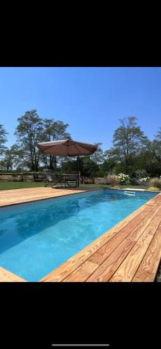a swimming pool with a picnic table and an umbrella at Ca di Timo B&B in Salionze