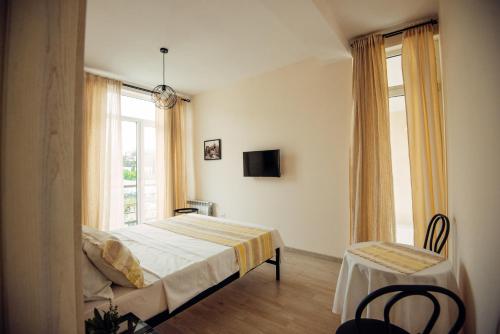 a bedroom with a bed and a window at Veronika Home Tbilisi in Tbilisi City
