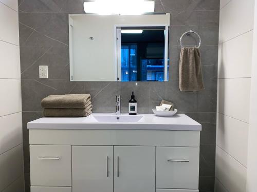 a bathroom with a white sink and a mirror at Mount Wycheproof Motor Inn in Wycheproof