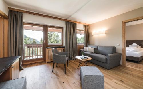 una camera d'albergo con divano e letto di Hotel Steger-Dellai ad Alpe di Siusi