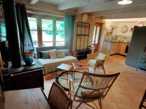 a living room with a couch and chairs at la bergerie de papé in Vimenet