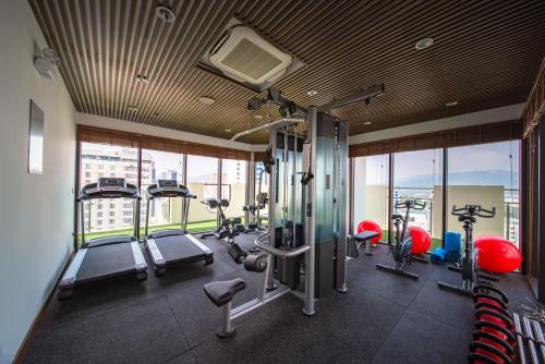 a gym with treadmills and exercise equipment in a building at Grand Tourane Nha Trang Hotel in Nha Trang