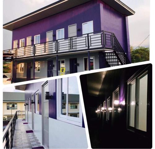 a purple building with a balcony on the side of it at JC Unit #8 in Urdaneta