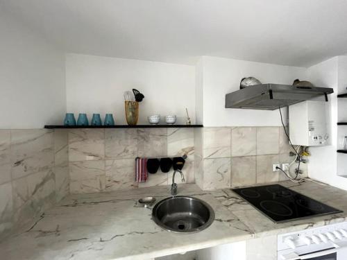 a kitchen with a sink and a counter top at Puskin Suite in Sines