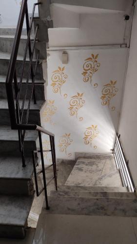 a staircase with gold designs on a wall at WHITE HOUSE Luxury Rooms - Loved by Travellers, Couples, Corporates in Jalandhar