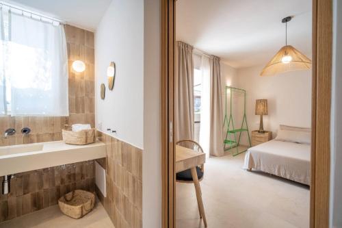 a bathroom with a sink and a bed in a room at B&B Antico Ulivo in Monopoli