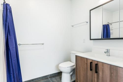 a bathroom with a toilet and a sink and a mirror at Central Sq Studio w Doorman nr Charles River BOS-369 in Cambridge