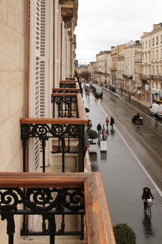 a row of benches on a city street at Maison d'hôtes Bordeaux Centre Le Patio de l'Intendance in Bordeaux