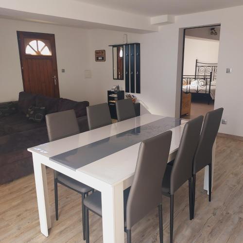 a white table and chairs in a living room at Au petit bois magique in Payrac
