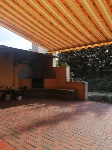 a patio with awning on top of a building at Ferien auf dem Land in Horka