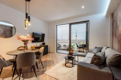 a living room with a couch and a table at Apartman Olimp in Metković