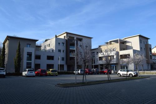 a parking lot with cars parked in front of buildings at MyVilla - Ivrea via Jervis 22b in Ivrea