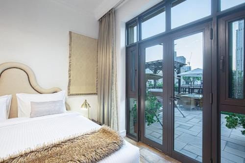 a bedroom with a bed and a sliding glass door at Tranquil Oasis- 2Bedroom, Connected to Dubai Mall in Dubai