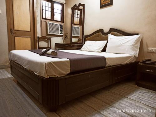 a bedroom with a large bed with a wooden frame at Grand tower Chennai in Chennai
