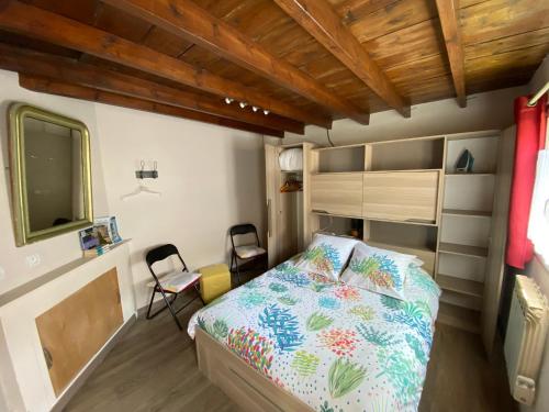 - une petite chambre avec un lit et deux chaises dans l'établissement Le vieux logis, à Étretat