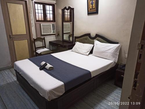 a bedroom with a bed with a hat on it at Grand tower Chennai in Chennai