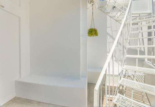 a white spiral staircase in a white house at The Roof-Top in Megalochori