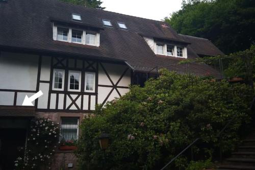 a white and black house with two windows at Ferienwohnung Martina & Augusto in Baden-Baden