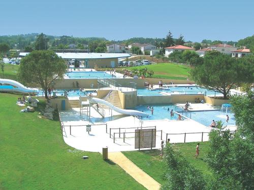 a large swimming pool with people in a park at Camping Onlycamp L'Argenté in Condom