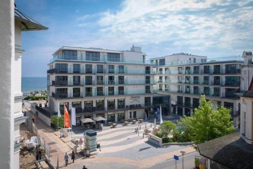 a large building with a plaza in front of the ocean at Villa Frohsinn App 15 in Bansin