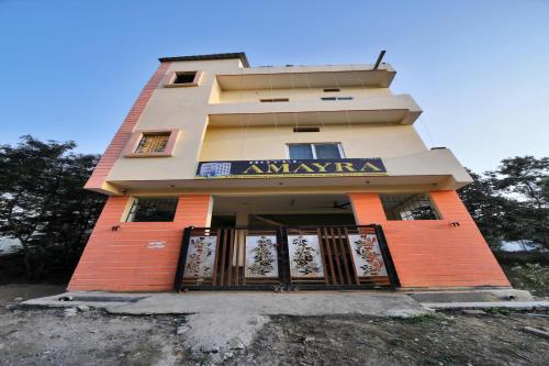 a building with a sign on the front of it at OYO Hotel Amaira in Bilāspur