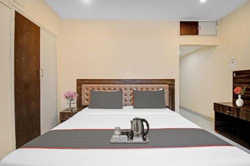 a bedroom with a bed with a blender on it at Super Capital O New All In One Near City Centre Salt Lake in Kolkata