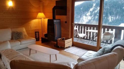 a living room with a couch and a stove at Heidi Chalet in Rossinière