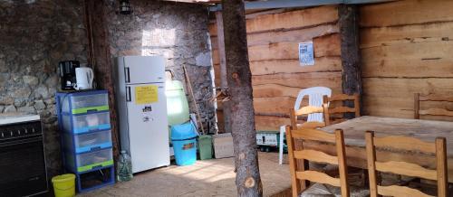 a kitchen with a refrigerator and a stove at Les Soleillas pour votre zen'ittude in Chalencon