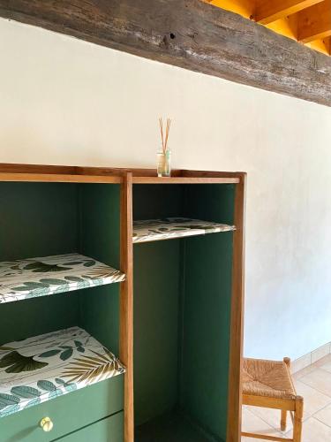 a room with two bunk beds and a chair at Domaine du Cellier de la Couronne in Sézanne