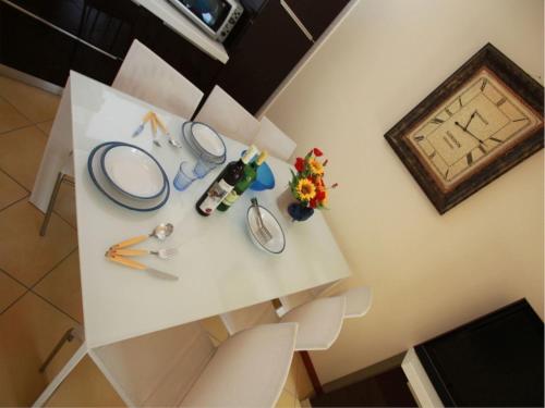 a white table with a mirror and flowers on it at Charming sea front view apartment-Beahost Rentals in Rosolina Mare