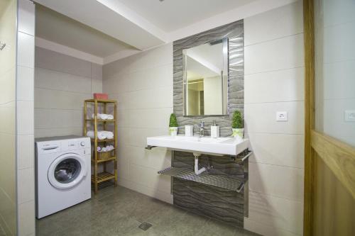 a bathroom with a sink and a washing machine at Campagna Mare in Kissamos