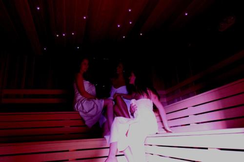 two women sitting on benches in a theatre at Wellness & Restaurant U Fandy in Lhotka