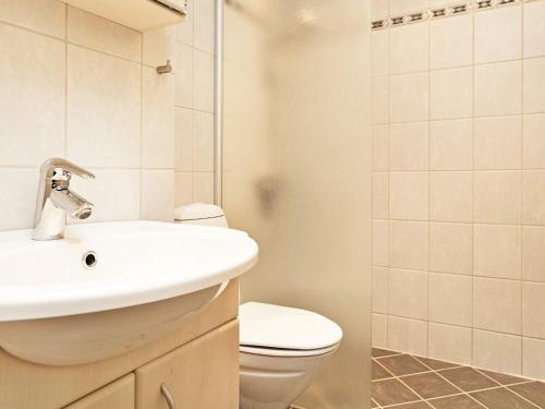 a bathroom with a sink and a toilet and a shower at Apartment Fanø VII in Fanø