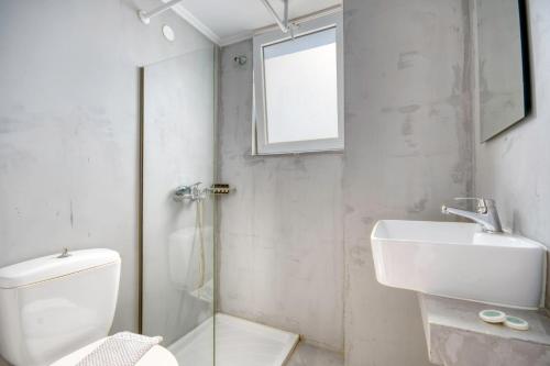 a bathroom with a toilet and a sink and a shower at Astron Hotel Rhodes in Rhodes Town