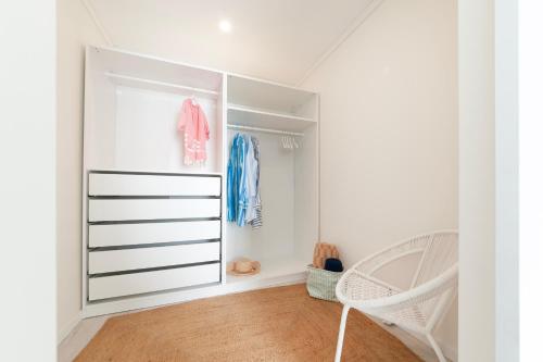 ein Schlafzimmer mit einem weißen Schrank mit einem Kinderbett in der Unterkunft Lilies Villa - BlueSea in Albufeira