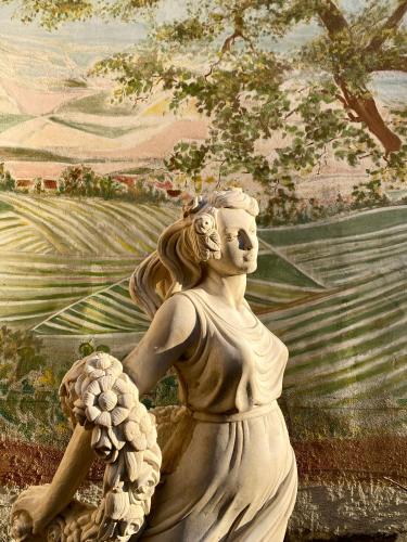 a painting of a statue of a woman in a field at Domaine du Cellier de la Couronne in Sézanne