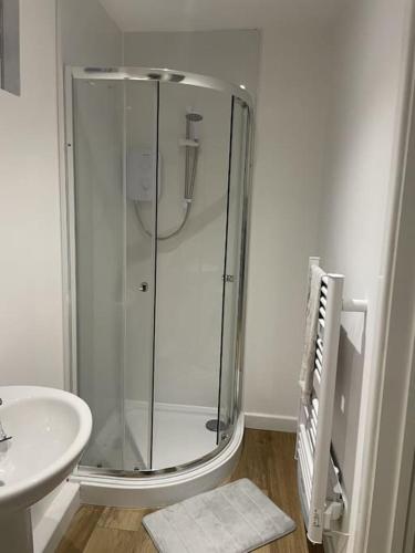 a bathroom with a shower and a sink at Poplar holiday cottage in Moulton Chapel