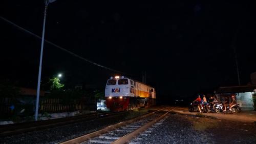 a train is coming down the tracks at night at The Kirana Purnama Semarang in Semarang