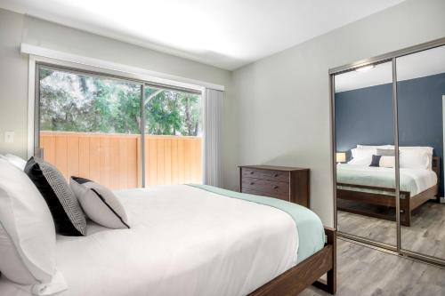 a bedroom with a large white bed and a mirror at Beverly Grove 2BR nr Cedar Sinai Hospital LAX-124 in Los Angeles