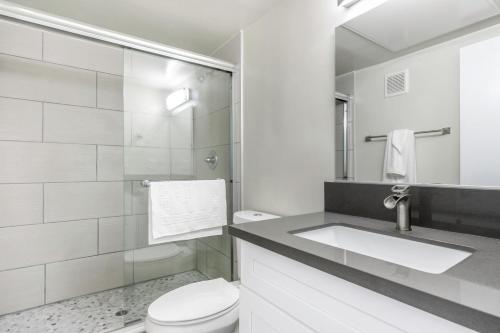 a white bathroom with a sink and a toilet at Beverly Grove 2BR nr Cedar Sinai Hospital LAX-124 in Los Angeles