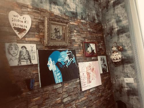 a brick wall with pictures and pictures on it at Lets Go - Apartment in Tbilisi City
