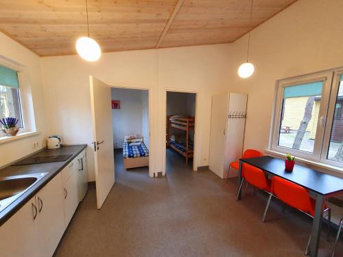 a kitchen with a table and a dining room at Pajūrio Kempingas in Klaipėda