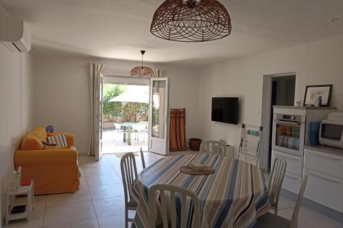 a kitchen and dining room with a table and chairs at Spacious apartment in the heart of Narbonne Plage in Narbonne