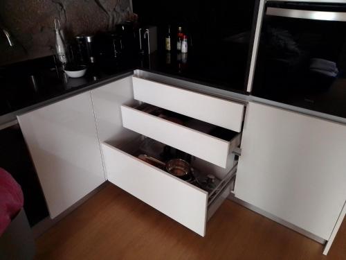 a white cupboard with a drawer in a kitchen at Casa da Florbela in Fafe