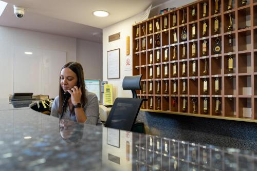 a woman talking on a cell phone in an office at Hotel Grand in Sarajevo