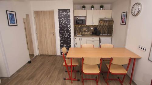 a kitchen with a table and chairs in a room at School Apartment - Your Unique Place in Prague by metro Vyšehrad in Prague