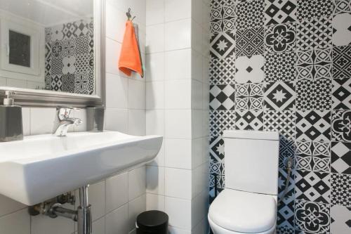 a white bathroom with a sink and a toilet at Modern flat in city center in Athens