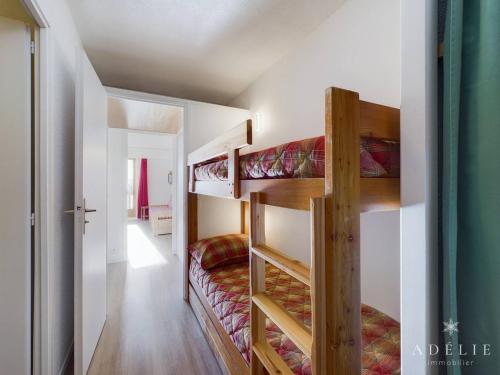 a room with two bunk beds and a hallway at Studio Montvalezan-La Rosière, 1 pièce, 6 personnes - FR-1-398-502 in La Rosière